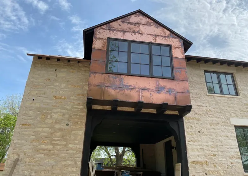 Copper metal panel facade on a stone building for Roof Repair in Woodcliff Lake