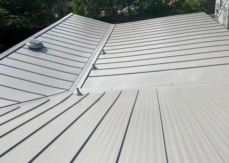 Solar attic fan installed on a metal roof for Roof Ventilation in Woodcliff Lake