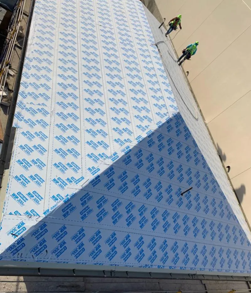 Professional roofers installing underlayment on a metal roof in Woodcliff Lake